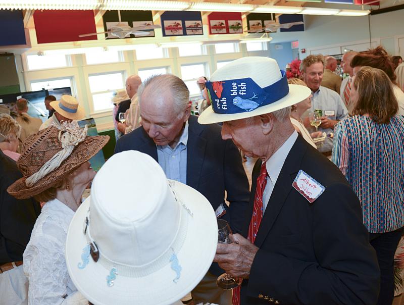 A group plans their winning hat strategy.